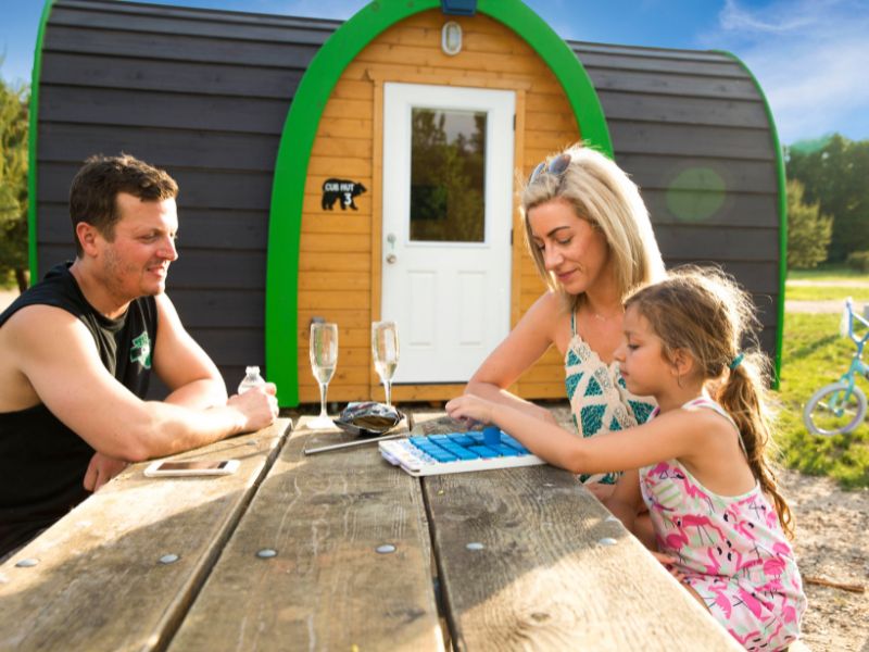 Family enjoying a game while camping