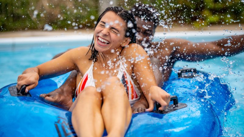 Couple laughing as getting drenched.