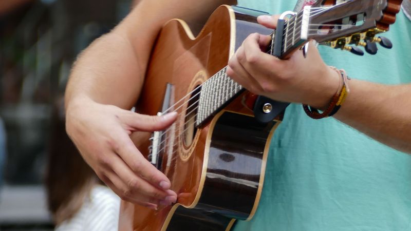 man playing the guitar at Labor Day weekend concerts at Lake Compounce 